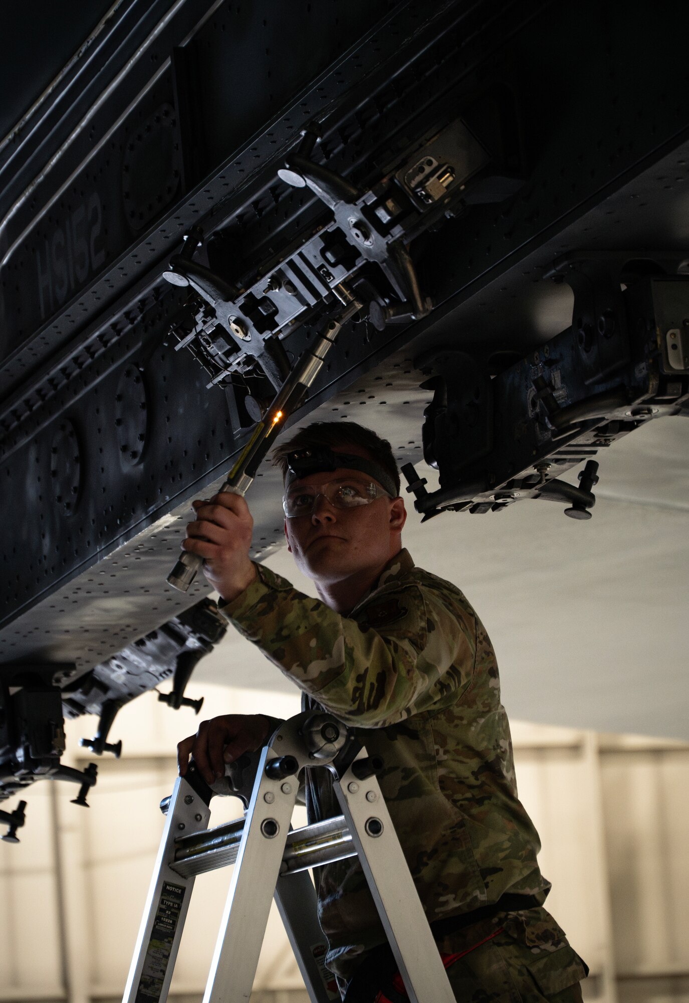 Senior Airman Nathan Whistler, 23rd Bomber Generation Squadron load crew member, prepares to secure inert GBU-31 Joint Direct Attack Munitions to a B-52H Stratofortress during the 1st Quarter Weapons Load Competition at Minot Air Force Base, May 2, 2025. In addition to the practical test, crews were given a written and dress and appearance inspection for the competition. (U.S. Air Force photo by Senior Airman Alyssa Bankston)