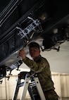 Senior Airman Nathan Whistler, 23rd Bomber Generation Squadron load crew member, prepares to secure inert GBU-31 Joint Direct Attack Munitions to a B-52H Stratofortress during the 1st Quarter Weapons Load Competition at Minot Air Force Base, May 2, 2025. In addition to the practical test, crews were given a written and dress and appearance inspection for the competition. (U.S. Air Force photo by Senior Airman Alyssa Bankston)