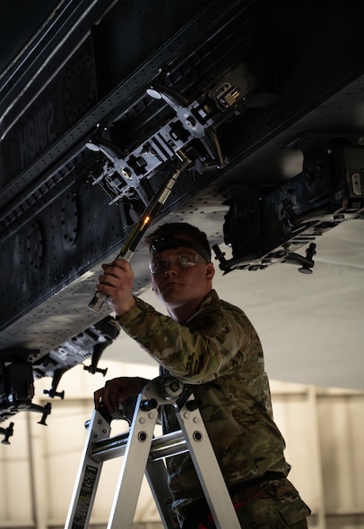 Senior Airman Nathan Whistler, 23rd Bomber Generation Squadron load crew member, prepares to secure inert GBU-31 Joint Direct Attack Munitions to a B-52H Stratofortress during the 1st Quarter Weapons Load Competition at Minot Air Force Base, May 2, 2025. In addition to the practical test, crews were given a written and dress and appearance inspection for the competition. (U.S. Air Force photo by Senior Airman Alyssa Bankston)