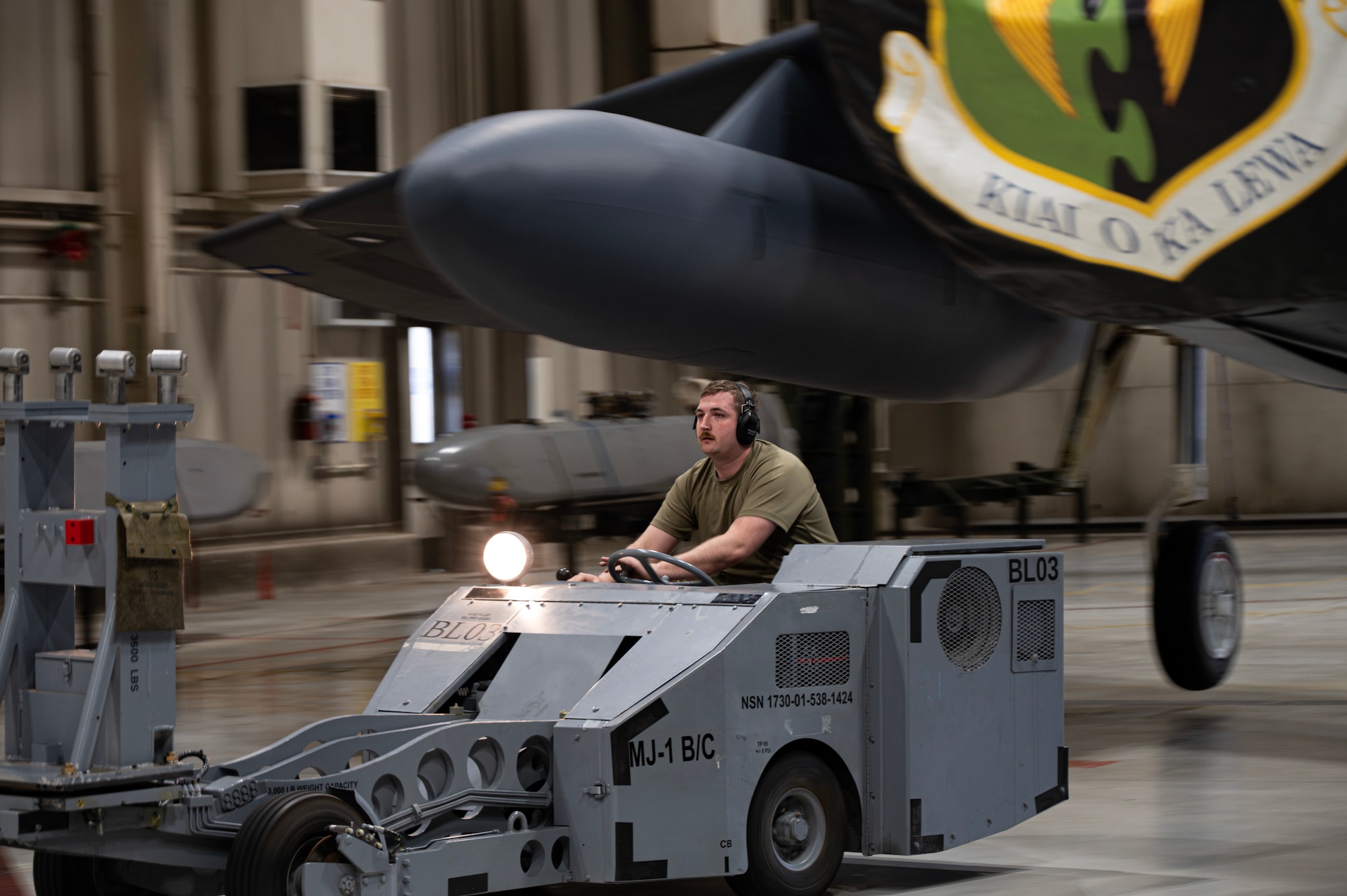 Senior Airman Joshua Boyle, 69th Bomber Generation Squadron load crew member, drives a missile carrier during the 1st Quarter Weapons Load Competition at Minot Air Force Base, May 2, 2025. For the inert munition to be loaded onto the aircraft safely and effectively, the crew must always have precise control over it. (U.S. Air Force photo by Senior Airman Alyssa Bankston)