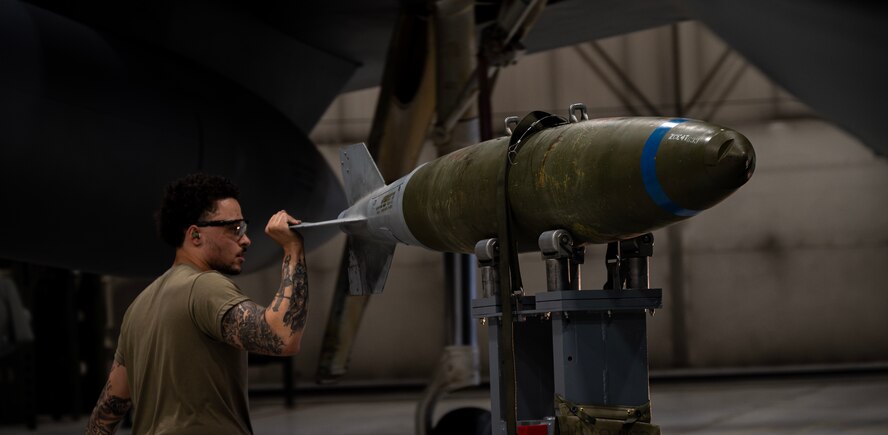 Senior Airman Nicholas Bowden, 69th Bomber Generation Squadron load crew member, prepares to secure an inert GBU-31 Joint Direct Attack Munition to a B-52H Stratofortress during the 1st Quarter Weapons Load Competition at Minot Air Force Base, May 2, 2025. For the inert munition to be loaded onto the aircraft safely and effectively, the crew must always have precise control over it. (U.S. Air Force photo by Senior Airman Alyssa Bankston)
