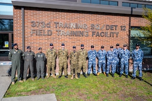 Kuwait Air Force Airmen, left, Royal Canadian Air Force Airmen, center, and Royal Australian Air Force Airmen stand together outside the 373rd Training Squadron, Detachment 12, at Joint Base Lewis-McChord, Washington, April 24, 2025.