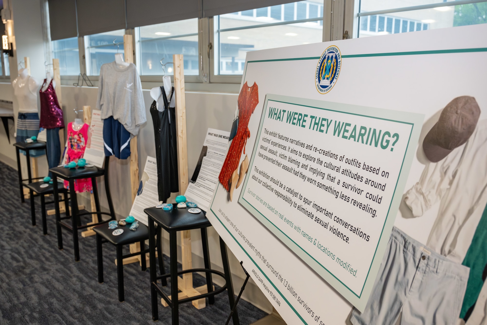 The “What Were They Wearing?” display, set up by the Arnold Air Force Base Sexual Assault Prevention and Response office, is shown in Hap’s Eatery at Arnold AFB, April 22, 2025. This exhibit featured narratives and recreations of outfits based on victims’ experiences and aimed to explore victim blaming and the false idea that a survivor could have prevented their assault had they worn something less revealing. The display was one of various events coordinated by the Arnold AFB SAPR team to coincide with Sexual Assault Awareness and Prevention Month, recognized each April. (U.S. Air Force photo by Keith Thornburgh)