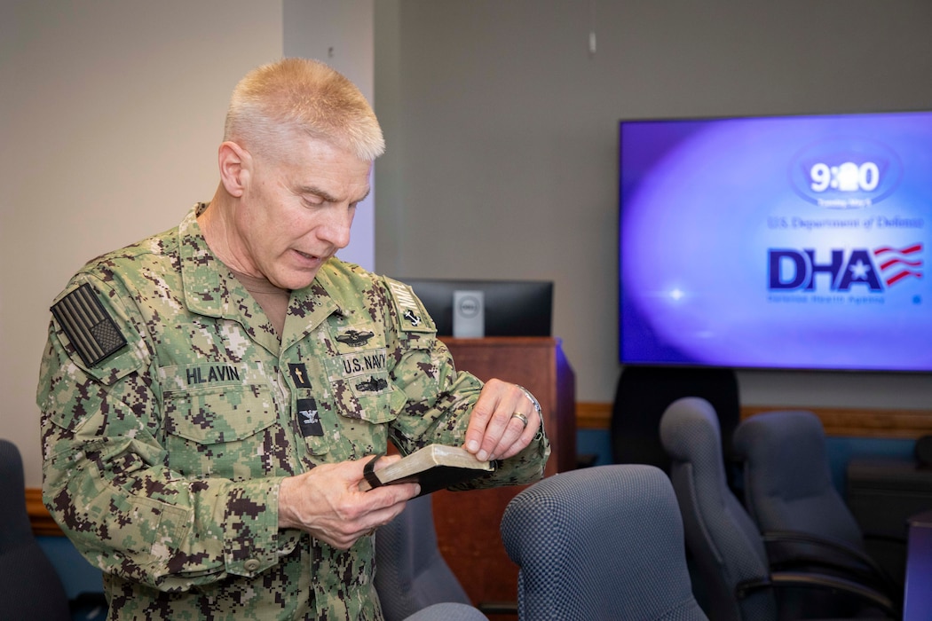 250506-N-KC192-1006 PORTSMOUTH, Va. (May 6, 2025) Capt. William Hlavin, the regional chaplain assigned to Naval Medical Forces Atlantic (NMFL), leads a prayer during a blessing of the hands ceremony held during National Nurses Week for NMFL nurses and staff as all are a part of the healing team onboard Naval Support Activity (NSA) Hampton Roads - Portsmouth Annex, May 6, 2025. Blessing of the hands is a moment of celebration and thanksgiving in recognition of a caregiver’s hands with oils or water and symbolizes how hands are used to deliver care and compassion. The Blessing of the Hands symbolizes the sacred role of healers and connects to Spiritual Readiness by affirming a caregiver’s sense of purpose, compassion, and inner strength to serve others with honor and resilience. (U.S. Navy photo by Mass Communication Specialist 2nd Class Levi Decker)