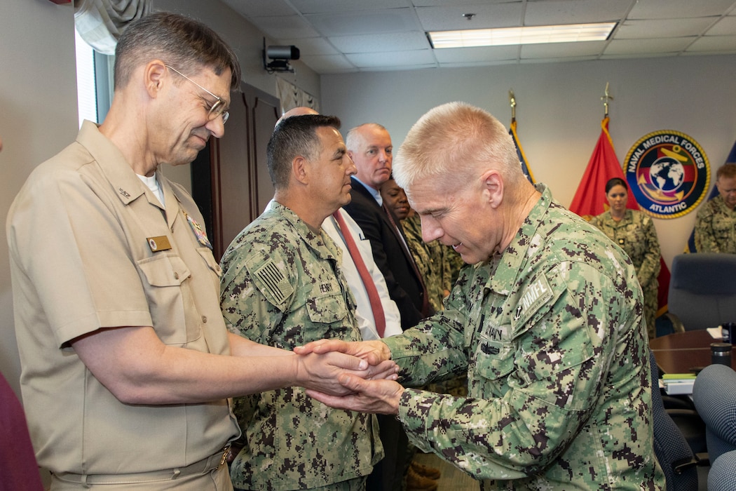 250506-N-KC192-1014 PORTSMOUTH, Va. (May 6, 2025) Capt. William Hlavin, the regional chaplain assigned to Naval Medical Forces Atlantic (NMFL), blesses the hands of Sailors and staff during a blessing of the hands ceremony held during National Nurses Week for NMFL nurses and staff as all are a part of the healing team onboard Naval Support Activity (NSA) Hampton Roads - Portsmouth Annex, May 6, 2025. Blessing of the hands is a moment of celebration and thanksgiving in recognition of a caregiver’s hands with oils or water and symbolizes how hands are used to deliver care and compassion. The Blessing of the Hands symbolizes the sacred role of healers and connects to Spiritual Readiness by affirming a caregiver’s sense of purpose, compassion, and inner strength to serve others with honor and resilience. (U.S. Navy photo by Mass Communication Specialist 2nd Class Levi Decker)