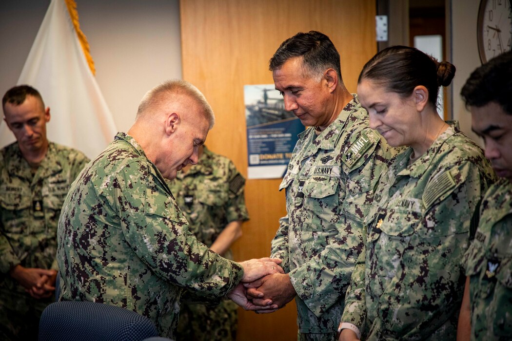 250506-N-KC192-1023 PORTSMOUTH, Va. (May 6, 2025) Capt. William Hlavin, the regional chaplain assigned to Naval Medical Forces Atlantic (NMFL), blesses the hands of Capt. Jose Pinon, the training officer assigned to NMFL, during a blessing of the hands ceremony held during National Nurses Week for NMFL nurses and staff as all are a part of the healing team onboard Naval Support Activity (NSA) Hampton Roads - Portsmouth Annex, May 6, 2025. Blessing of the hands is a moment of celebration and thanksgiving in recognition of a caregiver’s hands with oils or water and symbolizes how hands are used to deliver care and compassion. The Blessing of the Hands symbolizes the sacred role of healers and connects to Spiritual Readiness by affirming a caregiver’s sense of purpose, compassion, and inner strength to serve others with honor and resilience. (U.S. Navy photo by Mass Communication Specialist 2nd Class Levi Decker)
