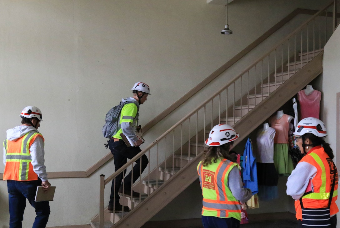 Civil engineers (structural) Ian Buchanan of the U.S. Army Corps of Engineers leads the way up the stairs as fellow engineer John Fogarty follows. Below fellow engineer Kayla Stull and debris removal subject matter expert Maria de la Torre await their turn, April 15.

USACE is working in partnership with local, state and the Federal Emergency Management Agency in response to the Southern California Wildfires.