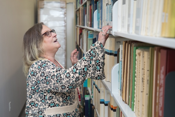 ERDC librarian looks at books on shelf