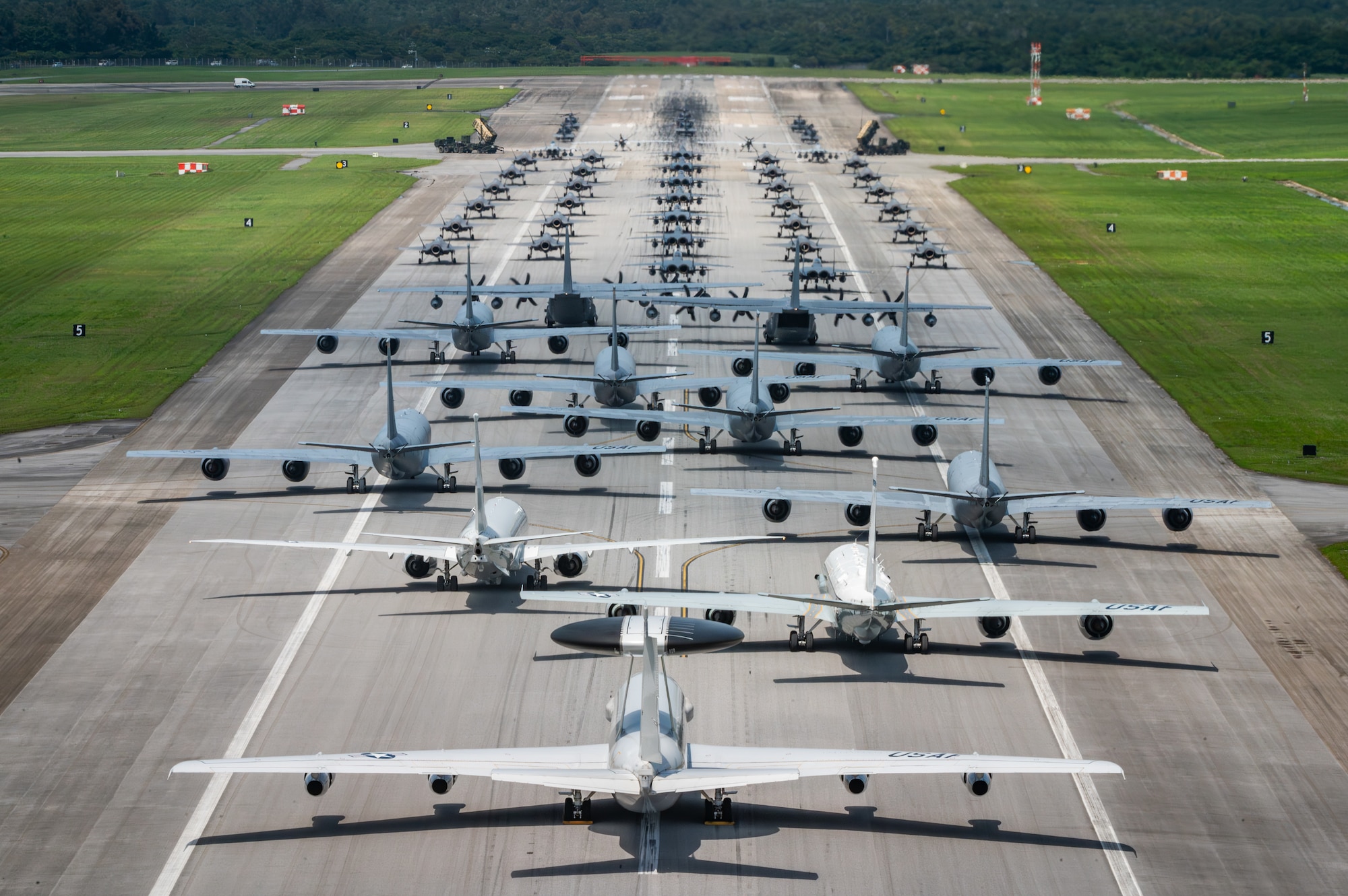 U.S. Air Force, Navy and Army assets line the runway for an elephant walk.