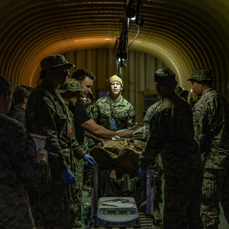U.S. Navy Lt. Andrei Lojek, an anesthesiologist with 1st Medical Battalion, 1st Marine Logistics Group, observes as Sailors evaluate a patient during a notional casualty scenario, part of a certification exercise on Marine Corps Base Camp Pendleton, California, April 22, 2025. The certification exercise is being conducted to demonstrate the ability to establish Role 2 capabilities through scenario-based training, which include strategies of effective Prolonged Casualty Care in austere environments that support warfighting efforts and increasing readiness as a forward deployable medical asset within I Marine Expeditionary Force. (U.S. Marine Corps photo by Cpl. Desiree Ruiz)