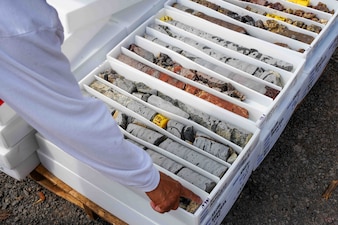 A geologist with Navy Closure Task Force-Red Hill (NCTF-RH) examines soil core samples collected during a groundwater monitoring well installation at the Red Hill Bulk Fuel Storage Facility (RHBFSF) in Honolulu, April 24, 2025. The Navy’s expansive well network in and around Red Hill provides valuable geologic and groundwater flow data in order to guide future monitoring and modeling efforts at RHBFSF. Charged with the safe decommissioning of the RHBFSF, NCTF-RH was established by the Department of the Navy as a commitment to the community and the environment. NCTF-RH continues to engage with the people of Hawaii, regulatory agencies, and other stakeholders as it safely and deliberately decommissions the facility. (U.S. Navy photo by Mass Communication Specialist 1st Class Glenn Slaughter)