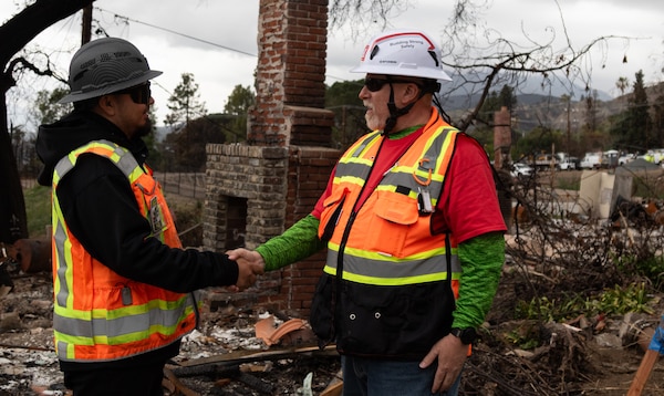 Arborist Victor Velazquez, from Tetra Tech, shakes hands with Greg Gully, contract engineer with USACE following Velazquez's inspection of questionable trees during the debris cleanup of the Southern California wildfires. 

USACE is working in partnership with local, state and the Federal Emergency Management Agency in response to the Southern California Wildfires.