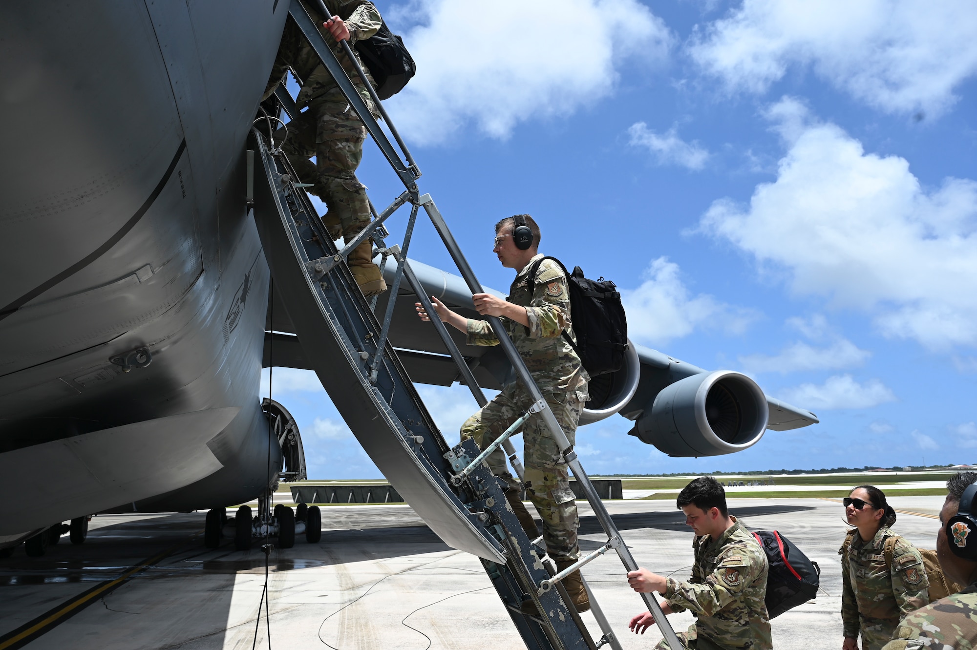 U.S. Air Force Airmen assigned to the 36th Tactical Advisory Squadron board the Lockheed C-5M Super Galaxy to prepare for takeoff at Andersen Air Force Base, Guam.