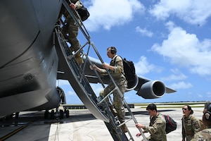 U.S. Air Force Airmen assigned to the 36th Tactical Advisory Squadron board the Lockheed C-5M Super Galaxy to prepare for takeoff at Andersen Air Force Base, Guam.