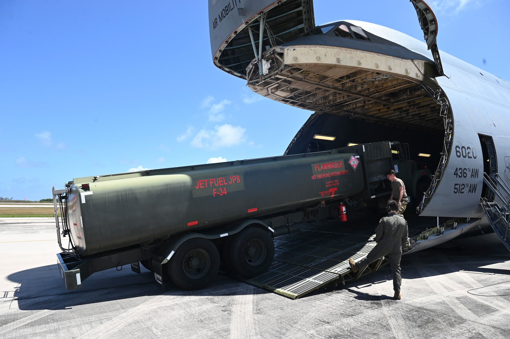 U.S. Air Force Airmen from the 554th RED HORSE Squadron unload an R-11 refueler to prepare for wet-wing defueling at Saipan International Airport.