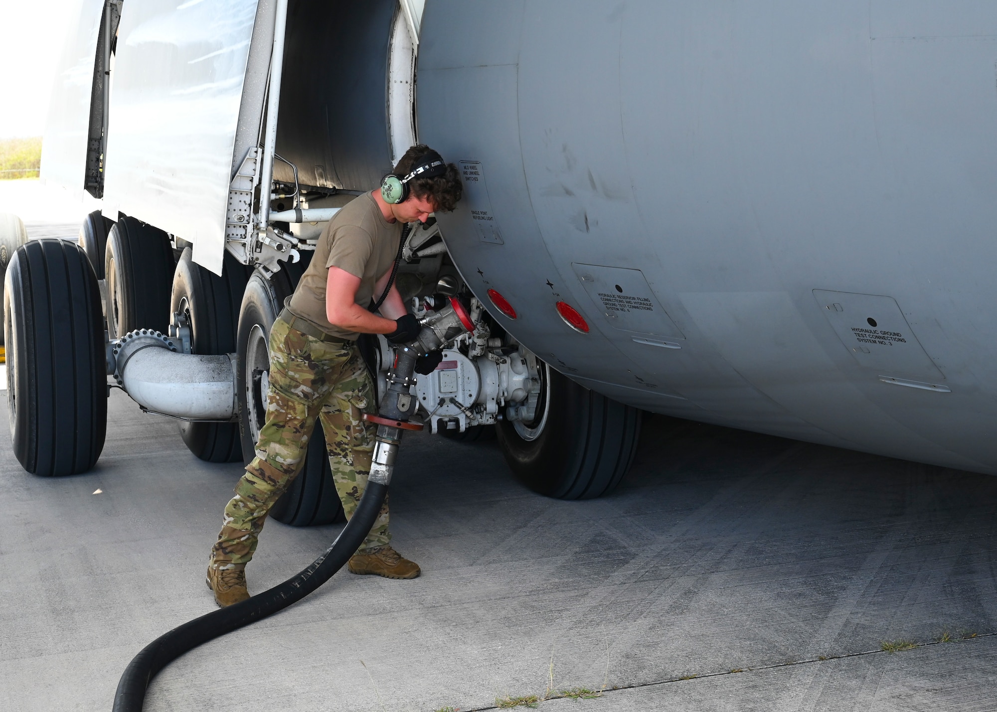 A U.S. Air Force Airmen from the 554th RED HORSE Squadron performs wet-wing defueling at Saipan International Airport.