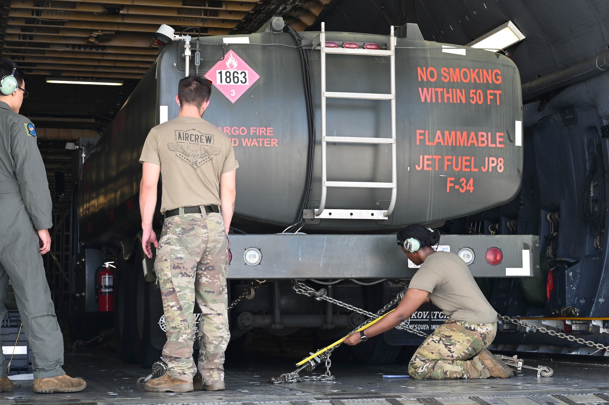 U.S. Air Force Airmen assigned to the 36th Wing prepare to unload an R-11 refueler truck off of a C-5M Super Galaxy.