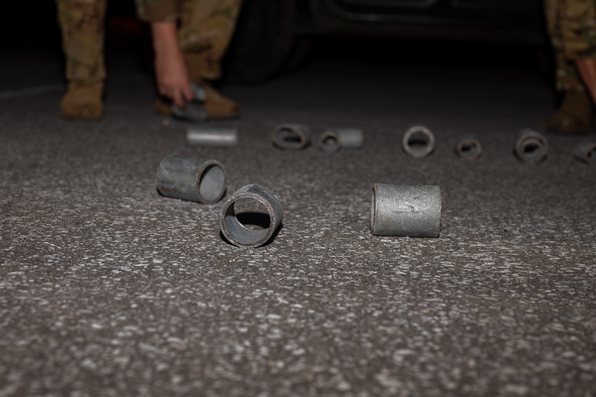 Airmen pick up simulated debris.