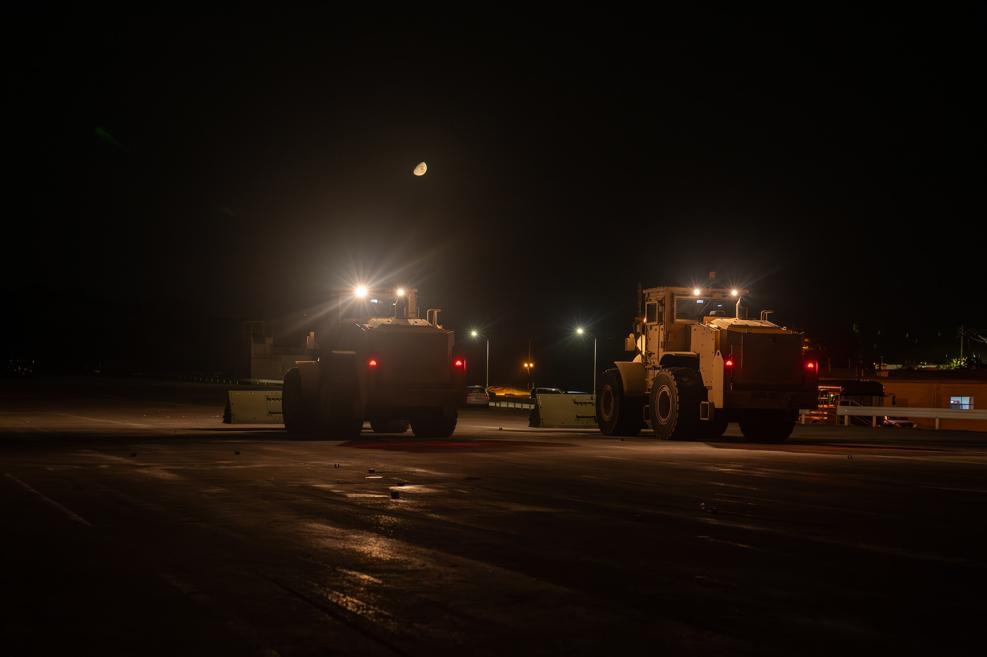 Front loaders sweep for debris.