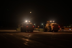 Front loaders sweep for debris.