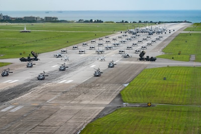 U.S. Air Force, Navy and Army assets line the runway for an elephant walk.