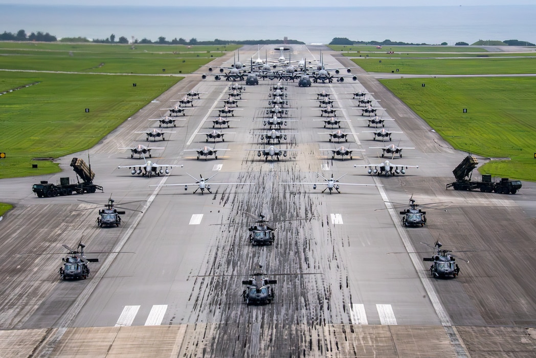 U.S. Air Force, Navy and Army assets line the runway for an elephant walk.