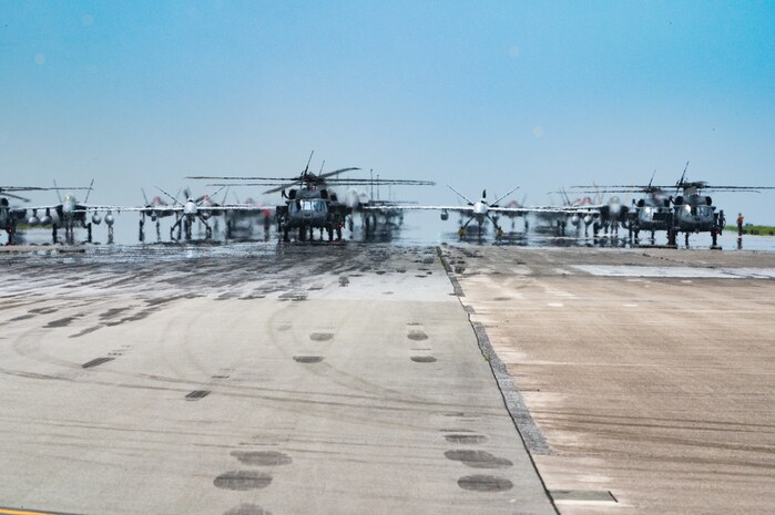 U.S. Air Force and Navy assets line the runway for an elephant walk.