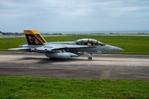An aircraft taxis down the runway.