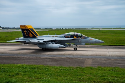 An aircraft taxis down the runway.
