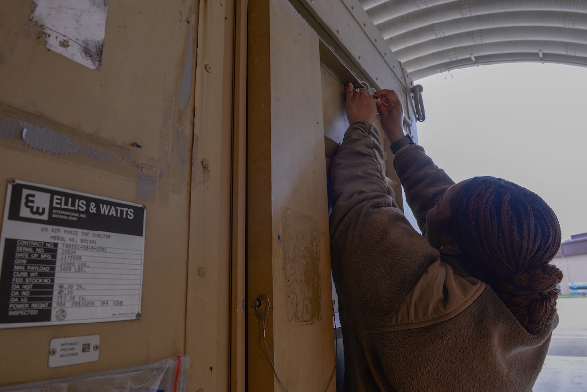 U.S. Air Force Staff Sgt. Kieara Obama, 51st Fighter Wing advanced programs office logistics manager, locks a deployable debrief facility at Osan Air Base, Republic of Korea, May 5, 2025. Part of the APO mission is to manage special access programs designed to control access, distribution, and protection of sensitive and classified information. Obama has quickly adapted and contributed to this mission since joining the APO team in October. (U.S. Air Force photo by Staff Sgt. Kahdija Slaughter)