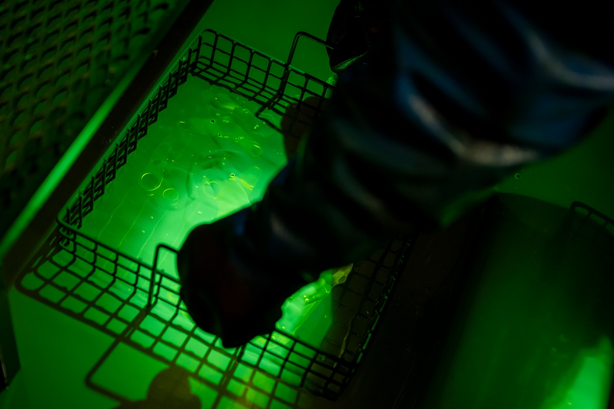 U.S. Air Force Airman Alejandro Ramirez, 35th Maintenance Squadron nondestructive inspection specialist, examines aircraft parts for defects.