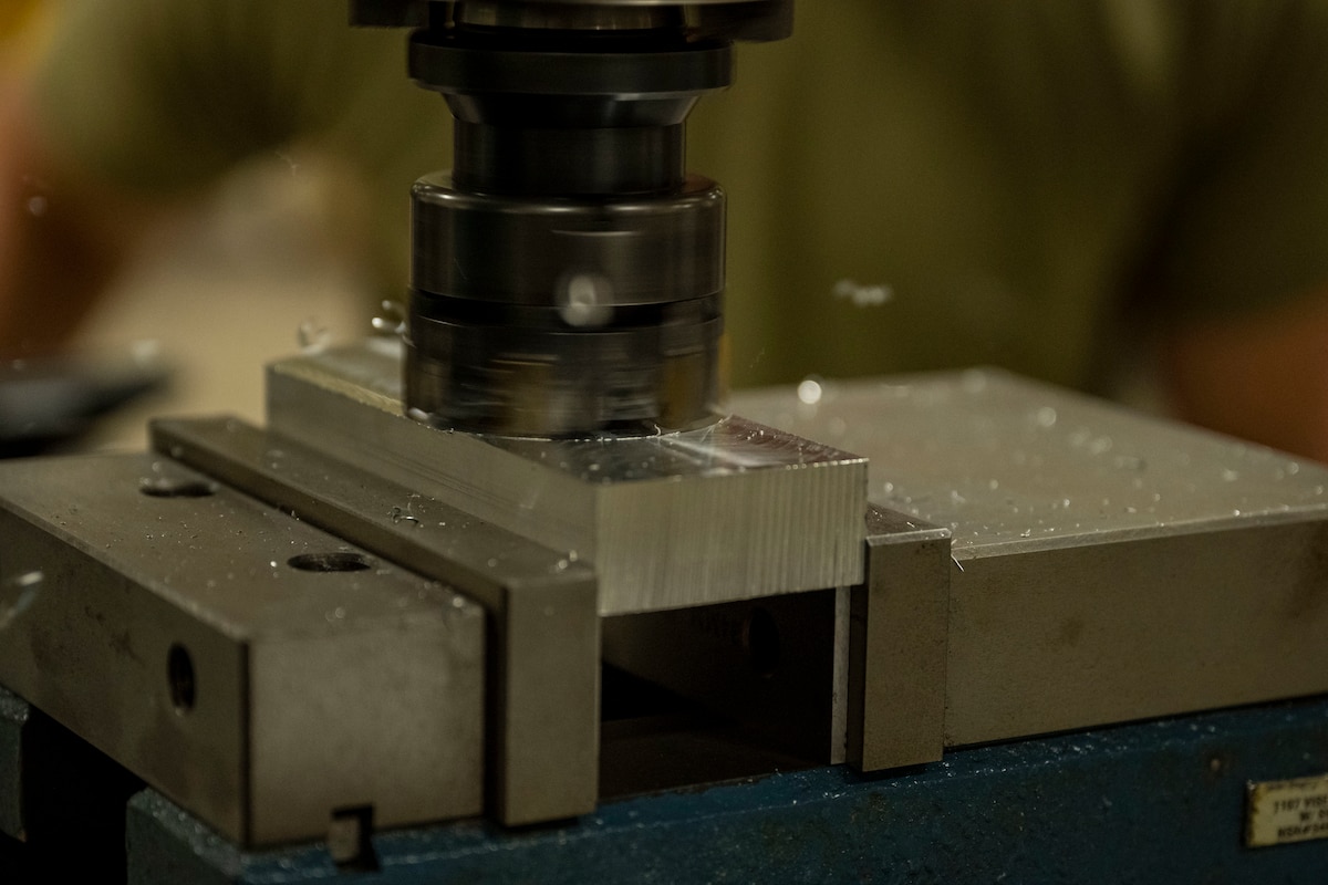 A computer numerical control mill is used on a component.