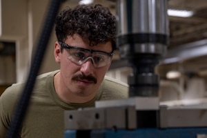 U.S. Air Force Senior Airman Jared Villalta, 35th Maintenance Squadron aircraft metals technology specialist, uses a computer numerical control mill on a component.