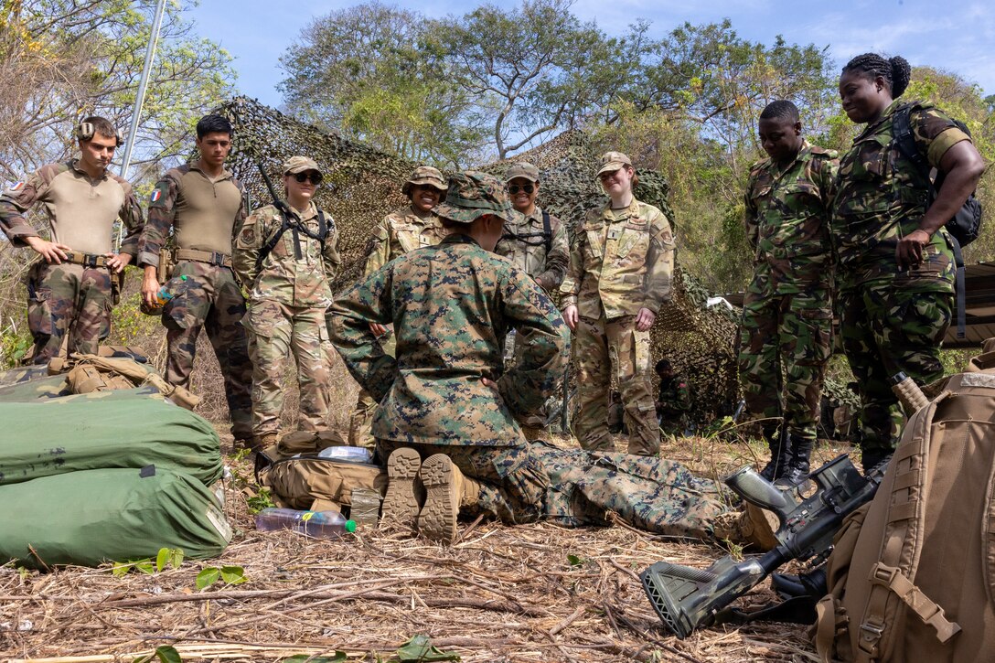 U.S. Navy Hospital Corpsman 3rd Class Hailey Lisska, center, assigned to Lima Company, 3rd Battalion, 25th Marine Regiment, instructs a course on tactical combat casualty care for members of the U.S. Air Force, Trinidad and Tobago Defence Force, and the French Army at Teteron Barracks in Teteron Bay, Trinidad and Tobago during TRADEWINDS 25 (TW25) April 30, 2025. TW25 is a U.S. Southern Command-sponsored, Chairman of the Joint Chiefs of Staff-approved annual exercise that enhances regional stability and demonstrates U.S. joint force coordination and interoperability with allies and partners. (U.S. Marine Corps photo by Lance Cpl. Payton Goodrich)