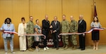 Justin Schmitt (center left), AVP of Corporate Responsibility, USAA, and Retired Rear Adm. Charles F. Williams, Chief of Staff, Armed Services YMCA, cut the ribbon to formally open Brooke Army Medical Center’s Armed Services YMCA Children’s Waiting Room, April 25, 2025, in the Putnam Auditorium. (DoD photo by Robert A. Whetstone)