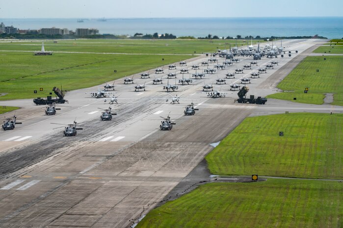 U.S. Air Force, Navy and Army assets line the runway for an elephant walk.