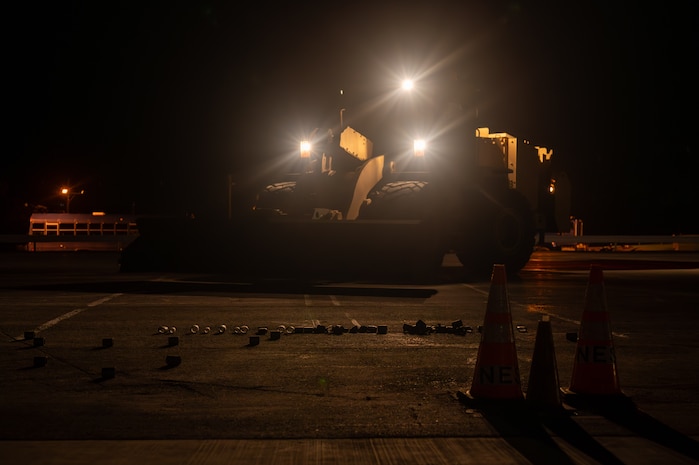 A front loader sweeps the runway.