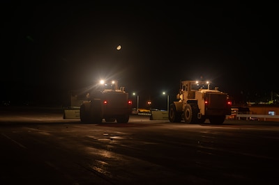 Front loaders sweep for debris.