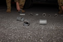 Airmen pick up simulated debris.