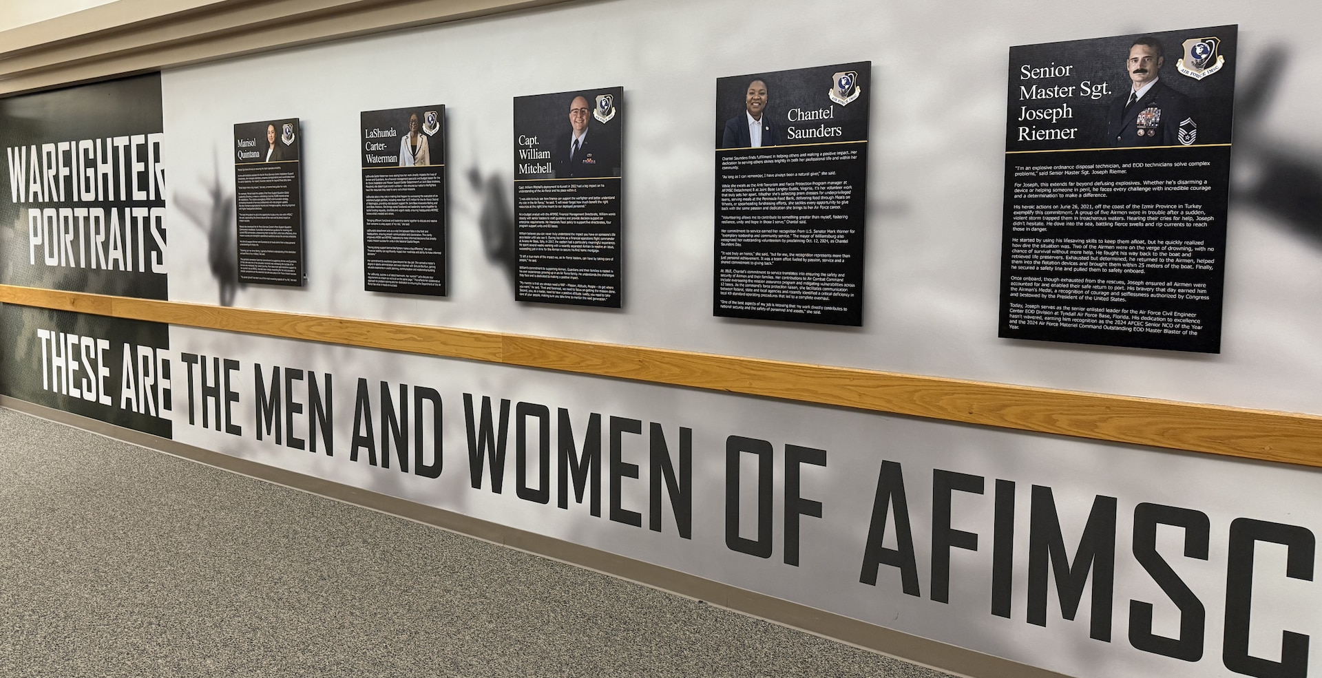 Photo of the AFIMSC Portraits displayed in the hallway of AFIMSC HQ.