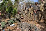 Navy Petty Officer 3rd Class Hailey Lisska, left, instructs a course on tactical combat casualty care for members of the U.S. Air Force, the Trinidad and Tobago military, and the French army during Tradewinds 25 in Teteron Bay, Trinidad and Tobago, April 30, 2025. The annual exercise enhances regional stability and demonstrates U.S. coordination with allies and partners.