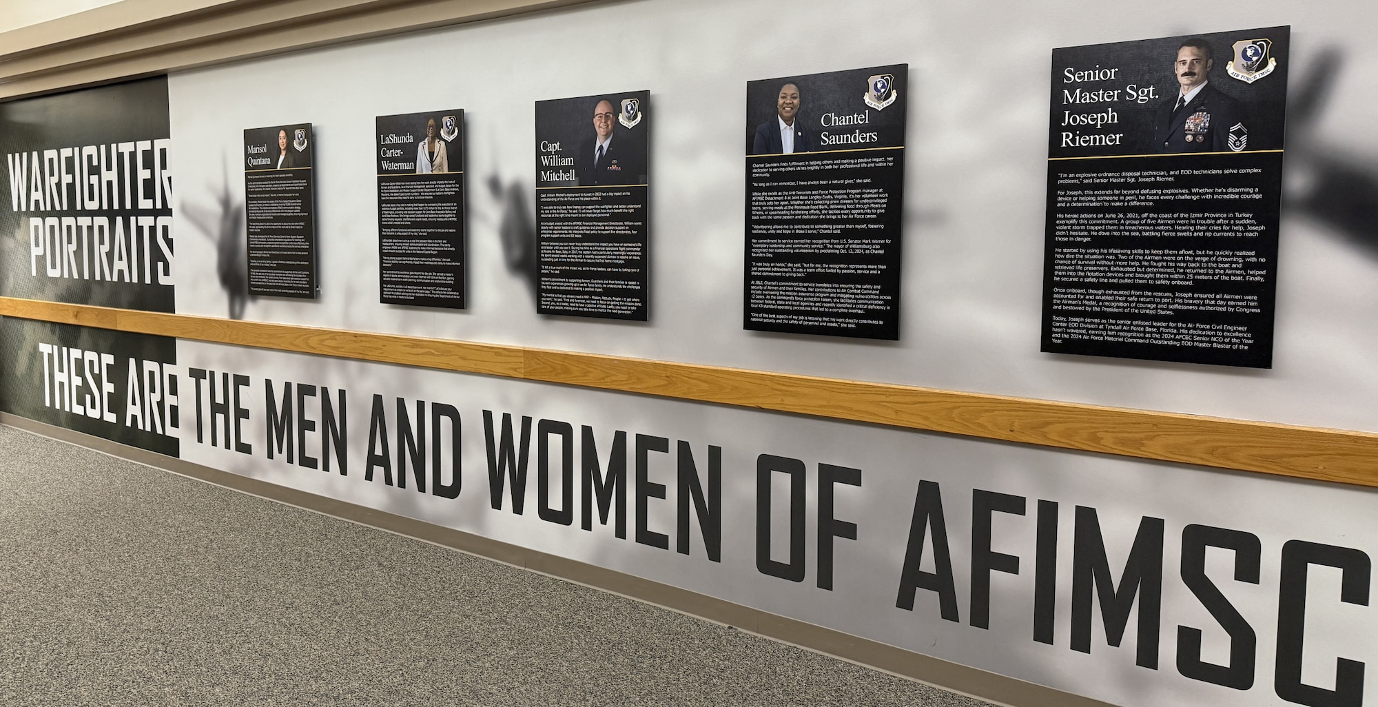 Photo of the AFIMSC Portraits displayed in the hallway of AFIMSC HQ.