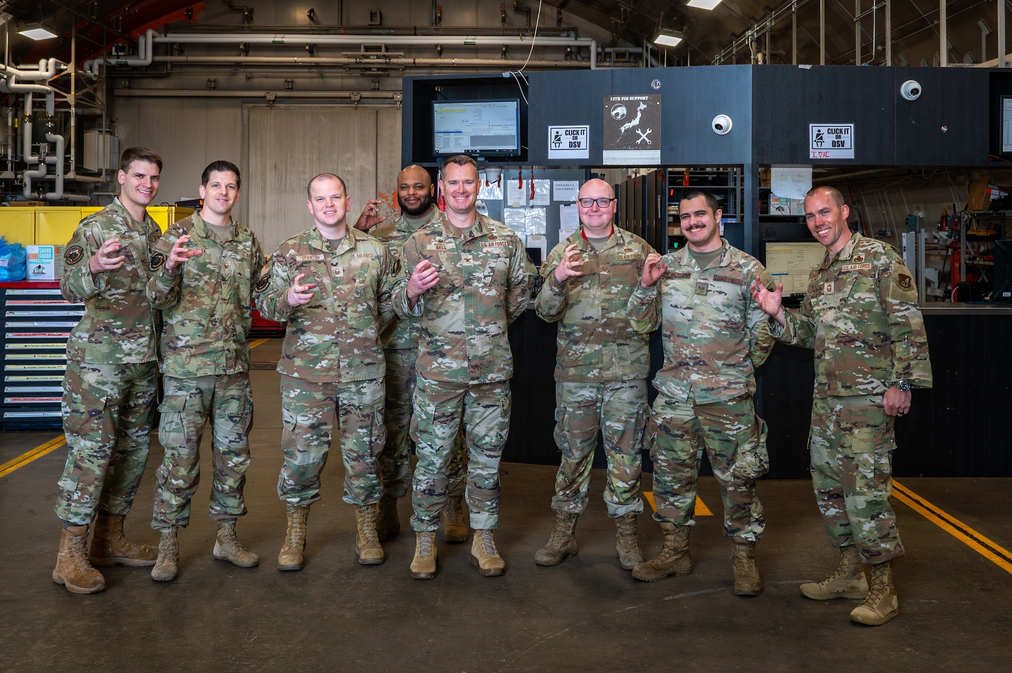 U S Air Force Colonel Jonathan Bell, 35th Mission Support Group commander, and members assigned to the 13th Fighter Generation Squadron pose for a group photo during a Wild Weasel Walk through at Misawa Air Base, Japan.