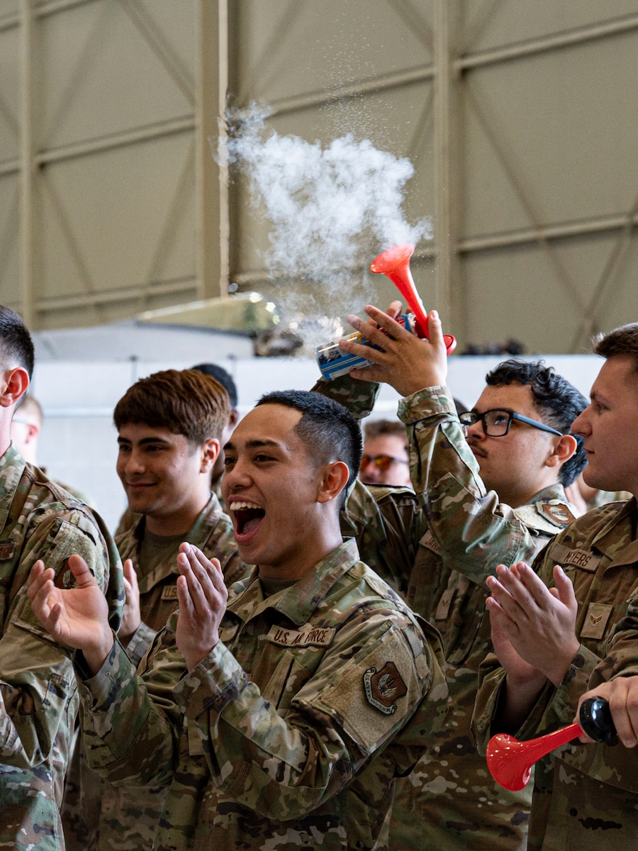 Service members cheer for newly appointed dedicated crew chiefs