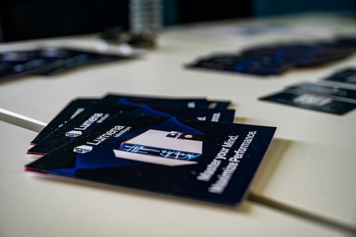 Lumena MindGym flyers sit on a table in foreground and background