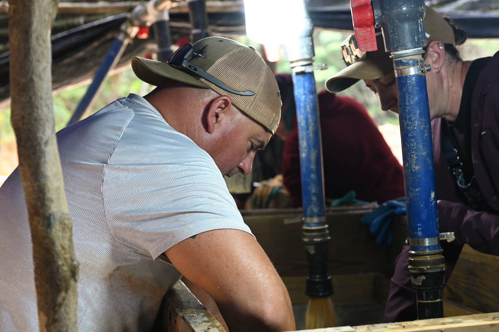 Oregon Army National Guard Sgt. 1st Class Nate Brushe, a recovery noncommissioned officer, wet-screens material during a Defense POW/MIA Accounting Agency (DPAA) recovery mission in Vietnam, April 11, 2025.