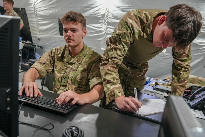 Royal Air Force military members from the 90th Signal Unit, Leeming, North Yorkshire, notify allied partners of PACE communication changes through JCHAT during the 2025 XCOMM Roundup at Robins Air Force Base.