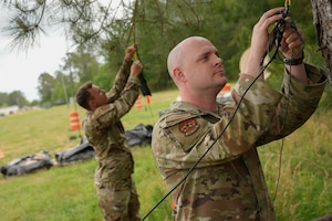 Air Force personnel from the 224th Joint Communications Support Squadron set up a high frequency field expedite antenna during the 2025 XCOMM Roundup