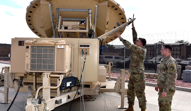 Army space professionals celebrate National Space Day on May 2 to recognize how they live and work every day. Spc. Klay Walker and Spc. Alexander Best with the 4th Space Company, 1st Space Battalion, work on a Mobile Integrated Ground Suite at Fort Carson, Colorado. The 1st Space Brigade recently conducted an expeditionary maneuver of transportable systems across combatant command areas of responsibility, demonstrating to allies and partners the readiness of the brigade and its subordinate units to deploy rapidly around the globe. (U.S. Army Photo by Dottie White)