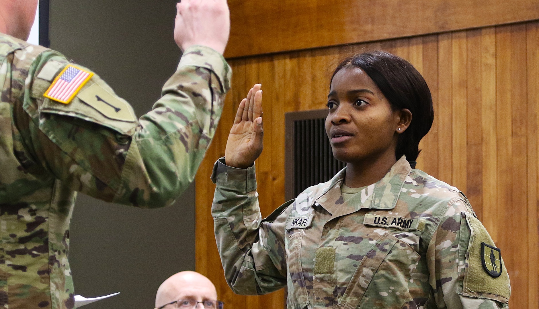 Juliana Nkafu takes the Oath of Office and commissions as a Illinois Army National Guard and U.S. Army second lieutenant during her April 26 commissioning ceremony.